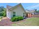 Home's back exterior with covered patio and manicured shrubbery at 85 Parks Pl, Sharpsburg, GA 30277
