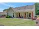 Backyard view of covered porch with ceiling fans and colorful columns at 85 Parks Pl, Sharpsburg, GA 30277