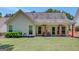 Backyard view of covered porch with ceiling fans and colorful columns at 85 Parks Pl, Sharpsburg, GA 30277