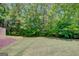 Lush green backyard with privacy trees and mulched bed at 85 Parks Pl, Sharpsburg, GA 30277