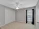 This well-lit bedroom boasts a ceiling fan and a closet, providing comfort and storage solutions at 85 Parks Pl, Sharpsburg, GA 30277