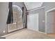Bedroom with a large window with curtains, carpeted floors, and a closet door at 85 Parks Pl, Sharpsburg, GA 30277