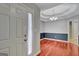 Formal dining room featuring wood floors, a tray ceiling, and a chandelier, adjacent to an entryway at 85 Parks Pl, Sharpsburg, GA 30277