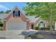 Charming brick home featuring an attached two-car garage and a well-manicured lawn with mature trees at 85 Parks Pl, Sharpsburg, GA 30277