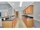 Well-lit kitchen features a peninsula with breakfast bar and stainless steel appliances at 85 Parks Pl, Sharpsburg, GA 30277
