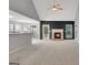 Bright living room featuring a fireplace, vaulted ceilings, and access to the backyard at 85 Parks Pl, Sharpsburg, GA 30277
