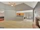 Bright living room featuring vaulted ceilings, a fireplace and views into the kitchen at 85 Parks Pl, Sharpsburg, GA 30277