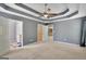 Large main bedroom with neutral carpet, gray walls, tray ceiling and doorways to bathroom and closet at 85 Parks Pl, Sharpsburg, GA 30277