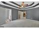 Large primary bedroom with tray ceilings leading to the main bathroom and walk-in closet at 85 Parks Pl, Sharpsburg, GA 30277