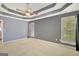 Large main bedroom suite features tray ceiling and natural lighting from large windows at 85 Parks Pl, Sharpsburg, GA 30277
