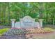 Parkside Village sign with lush greenery and blooming flowers at 85 Parks Pl, Sharpsburg, GA 30277