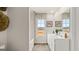 Bright bathroom featuring a double sink vanity, framed mirrors, and window offering outdoor views at 310 Sound Circle, Stockbridge, GA 30281