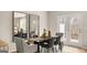 Elegant dining room with modern table setting, gray chairs, mirrors and balcony access at 310 Sound Circle, Stockbridge, GA 30281
