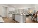Open-concept kitchen flows into living area with stainless appliances and center island with bar stool seating at 310 Sound Circle, Stockbridge, GA 30281