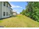Spacious backyard with lush green lawn and mature trees at 361 Traditions Ln, Hampton, GA 30228