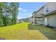 Lush backyard featuring a covered patio and green lawn at 361 Traditions Ln, Hampton, GA 30228