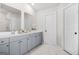 Bathroom featuring a double sink vanity with gray cabinets and modern fixtures at 361 Traditions Ln, Hampton, GA 30228