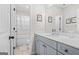 A well-lit bathroom with gray cabinets and a shower/tub combination at 361 Traditions Ln, Hampton, GA 30228