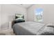 Cozy bedroom featuring a large window and TV setup at 361 Traditions Ln, Hampton, GA 30228