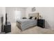 Neutral bedroom with carpet, bed, television, and a dark-wood bookcase at 361 Traditions Ln, Hampton, GA 30228