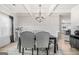 Bright dining area features modern lighting, coffered ceilings, and a view into a well-appointed kitchen at 361 Traditions Ln, Hampton, GA 30228