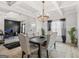 Elegant dining room with coffered ceilings, stylish chandelier, and sophisticated decor for gatherings at 361 Traditions Ln, Hampton, GA 30228
