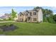 Spacious two-story home with brick facade, landscaped yard, and a welcoming front entrance on a grassy lawn at 361 Traditions Ln, Hampton, GA 30228