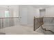 Carpeted upstairs hallway with view of the stairwell at 361 Traditions Ln, Hampton, GA 30228