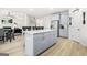 The kitchen area has an island with barstool seating and a view to the living area and stairs at 361 Traditions Ln, Hampton, GA 30228