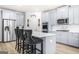 Modern kitchen features stainless steel appliances, a center island with seating, and sleek countertops at 361 Traditions Ln, Hampton, GA 30228