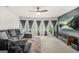 Spacious living area with a large grey sofa, multiple windows, and media center with mounted TV at 361 Traditions Ln, Hampton, GA 30228