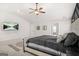 The carpeted main bedroom includes a large bed, ceiling fan, and a wall-mounted television at 361 Traditions Ln, Hampton, GA 30228