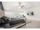 A spacious carpeted main bedroom features a ceiling fan and a wall-mounted television at 361 Traditions Ln, Hampton, GA 30228