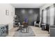 Modern office space with sleek gray decor, including statement wall, stylish desk, and comfortable seating at 361 Traditions Ln, Hampton, GA 30228