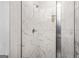 Close up of the shower with marble-style tiles and glass enclosure at 361 Traditions Ln, Hampton, GA 30228