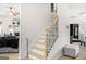 Staircase with wood and white trim, and wrought iron spindles at 361 Traditions Ln, Hampton, GA 30228