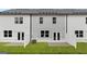 Townhome backyards with private patio and lawn area, and white privacy fence at 314 Sound Cir, Stockbridge, GA 30281