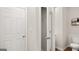 Hallway bathroom shows closet and toilet, natural paint, and wood floors at 314 Sound Cir, Stockbridge, GA 30281