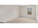 Unfurnished bedroom shows window views, plush carpet, and neutral paint at 314 Sound Cir, Stockbridge, GA 30281