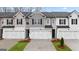 Modern townhome featuring a two-car garage, manicured lawn, and gray and white color scheme at 314 Sound Cir, Stockbridge, GA 30281