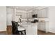 Bright kitchen with gray cabinets, granite countertops, stainless steel appliances, and a central island with seating at 314 Sound Cir, Stockbridge, GA 30281
