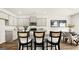 Modern kitchen with gray cabinets, granite countertops, stainless appliances, and a central island with chairs at 314 Sound Cir, Stockbridge, GA 30281
