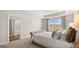 Spacious main bedroom featuring a queen-sized bed, stylish decor, and a view to the ensuite bathroom at 314 Sound Cir, Stockbridge, GA 30281
