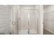 Modern bathroom featuring a tiled shower with a glass door, showcasing a clean and contemporary design at 314 Sound Cir, Stockbridge, GA 30281