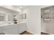 Bright bathroom with double sink vanity, woodgrain floors and a closet with shelving at 318 Sound Circle, Stockbridge, GA 30281