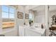 A modern bathroom with double vanity, ample natural light, and stylish fixtures at 318 Sound Circle, Stockbridge, GA 30281