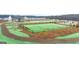 Aerial view of the community park featuring walking paths, a fenced lawn, and a playground at 318 Sound Circle, Stockbridge, GA 30281