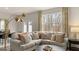 Bright living room featuring a neutral sectional sofa, large windows, and modern decor at 318 Sound Circle, Stockbridge, GA 30281