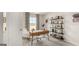 A bright office space with a wooden desk, stylish shelving, and a window view at 318 Sound Circle, Stockbridge, GA 30281