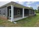 Covered back porch with white pillars and brick accents at 1676 Fuma Leaf Way # 305, Mcdonough, GA 30253